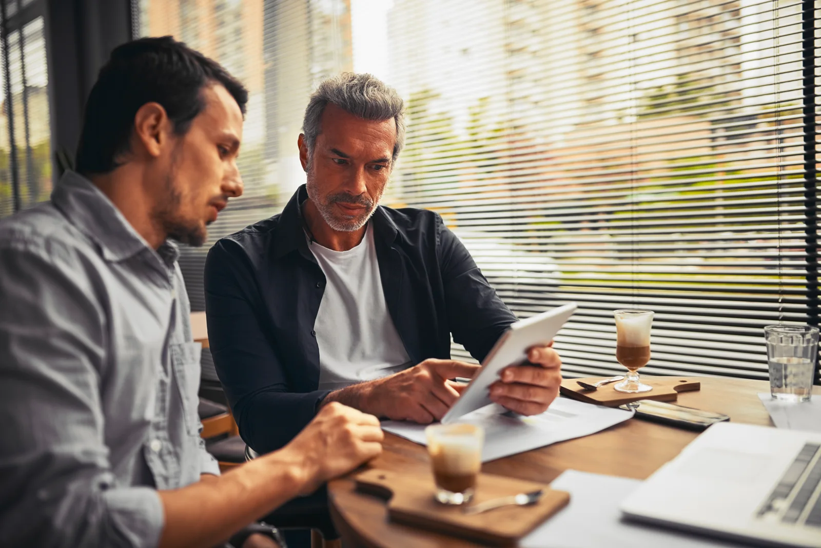 Business owner and accountant discussing the quarterly figures over a tablet